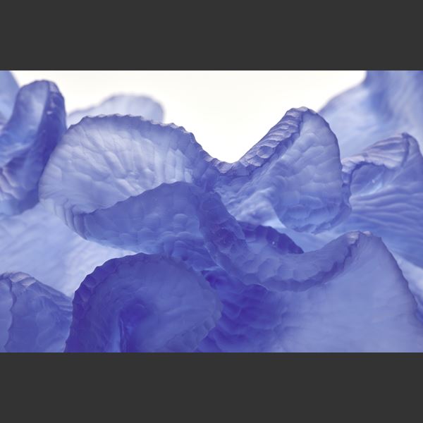 rich royal blue abstract sculpture with textured surface with the appearance of coral with frilled edges hand made from glass