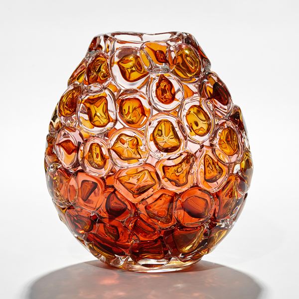 soft squat oval vase in rich amber peach and gold covered in bubbles that resemble oversized bubblewrap packaging hand made from glass
