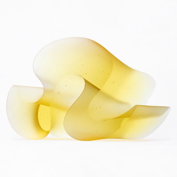 brilliant yellow standing form with two flat shiny sides and sweeping matt curved side with the appearance of a curling thick ribbon or arabic text