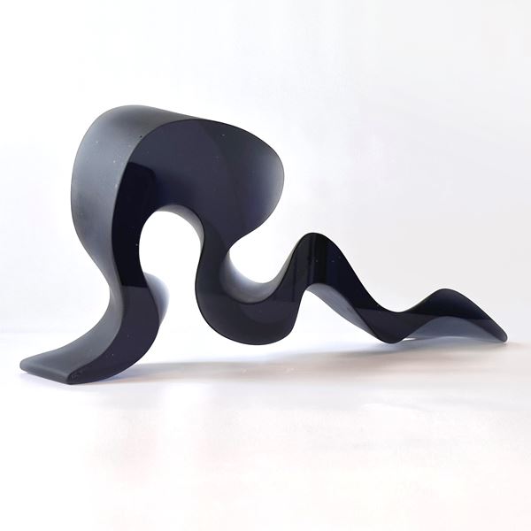 deep steel blue grey abstract simplified snake sculpture with fluid lines and two flat polished sides hand made from glass
