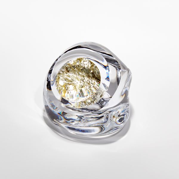 small clear smooth rock with interior filled with white gold hand blown and sculpted from glass