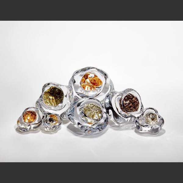 small clear smooth rock with interior filled with white gold hand blown and sculpted from glass