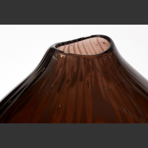 rich dark plum coloured vessel with subtle organic surface texture with amorphic shape and offset top opening hand made from glass