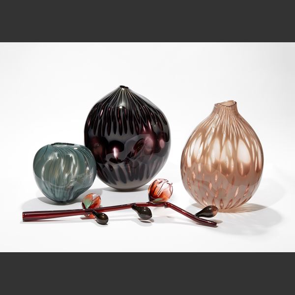 asymmetric dark purple and milky grey hand blown glass vessel resembling an abstract poppy seed head