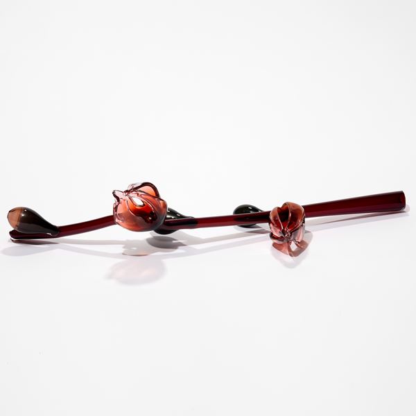 prone oxblood red stem with abstract flowers and buds in pink red and celadon hand made from sculpted glass