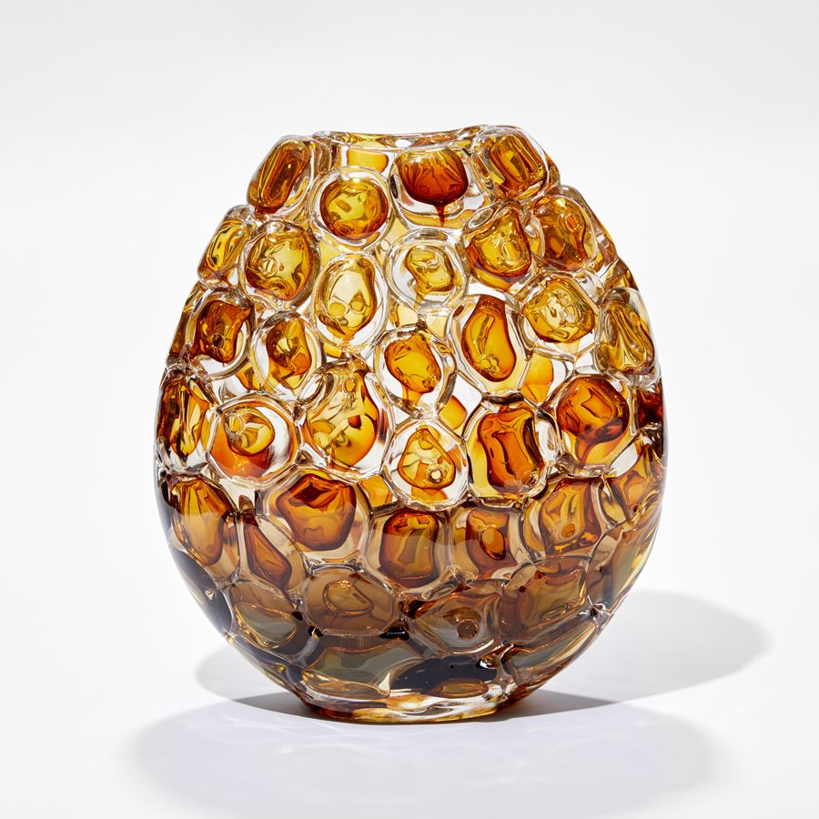 oval vase in rich amber and clear glass with the outside covered in oversized bubbles with the appearance of bubblewrap hand blown from glass