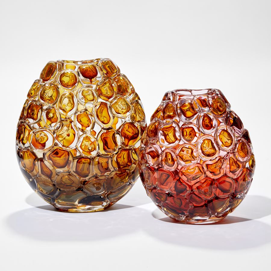 oval vase in rich amber and clear glass with the outside covered in oversized bubbles with the appearance of bubblewrap hand blown from glass