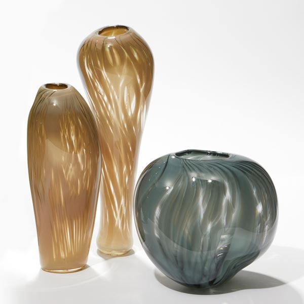 soft fawn brown and transparent tall vase with widening bulbous top with see through sections hand made from glass