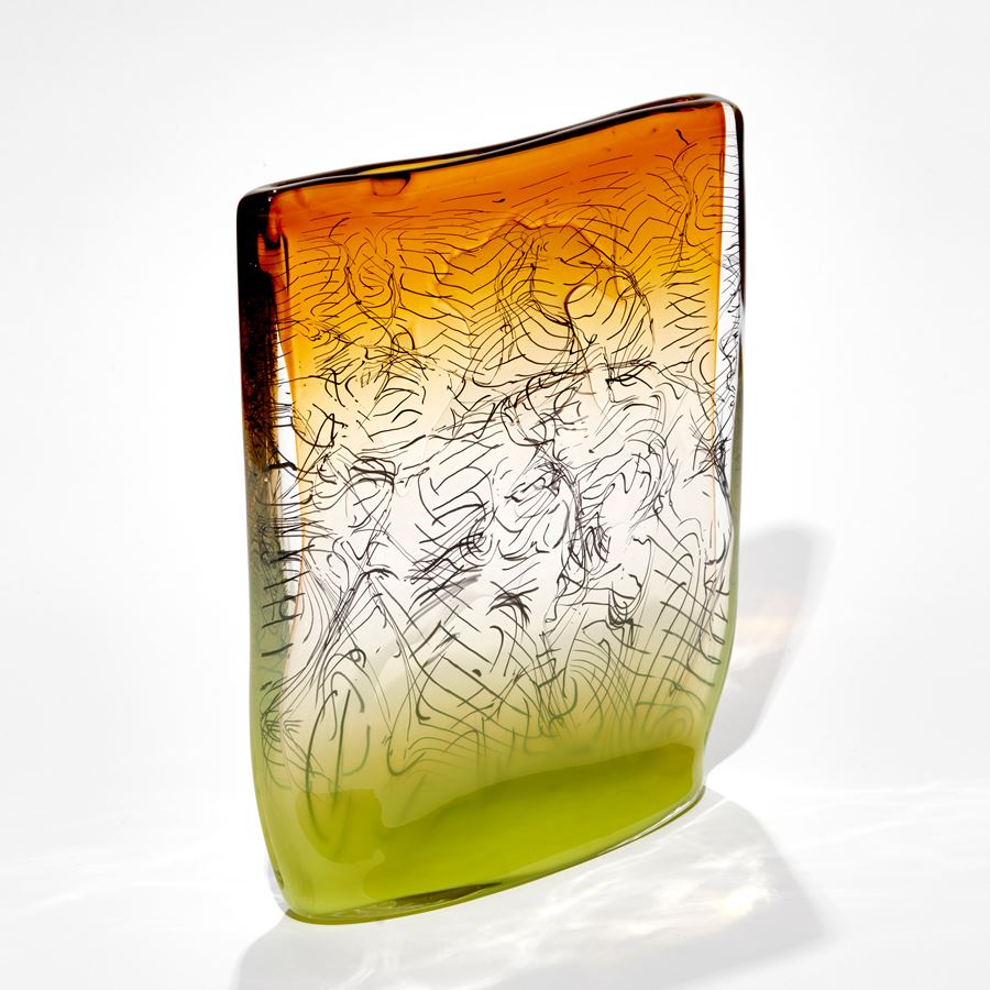 square sculpture with lime base fading to clear then ochre amber yellow with trapped black lines hand made from glass