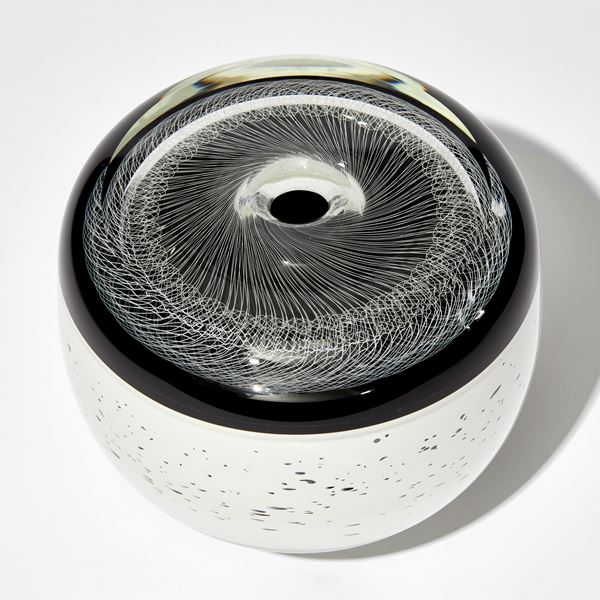 monochrome artwork with spirograph style pattern on the top and white base speckled with black hand made from glass