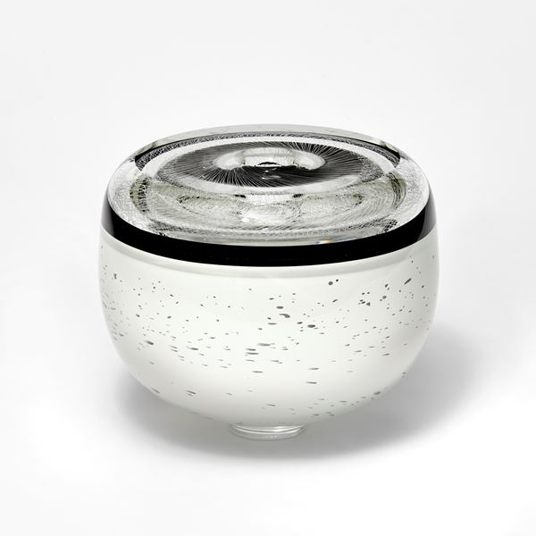 monochrome artwork with spirograph style pattern on the top and white base speckled with black hand made from glass