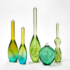 group of five scientific looking bottles in differing shapes in green and turquoise each contacting a helix spiral of inner detail and trapped bubbles