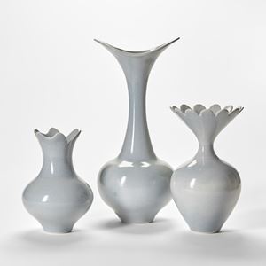 three soft pigeon blue grey elegant hand thrown porcelain vases with rounded bases narrowing necks and flared tops with scalloped edges
