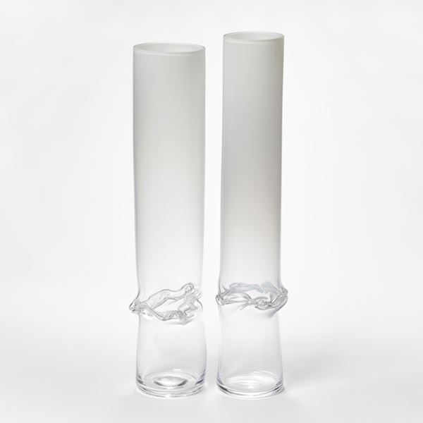 hand made glass sculptural cylinder with clear base fading to opaque white with dividing wrinkled and rippled waist section