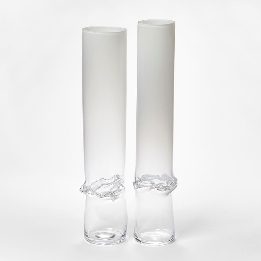 hand made glass sculptural cylinder with clear base fading to opaque white with dividing wrinkled and rippled waist section