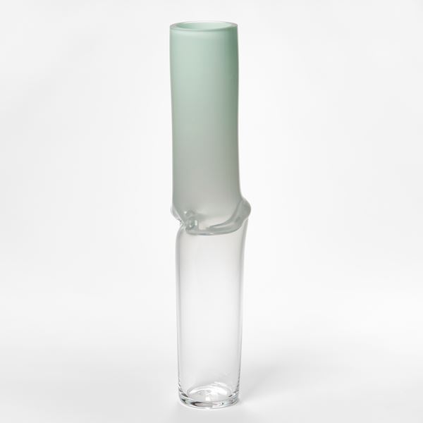 tall cylinder traversing and fading from clear at the base to opaque soft mint green at the top with a creased and rippled centre hand made from glass