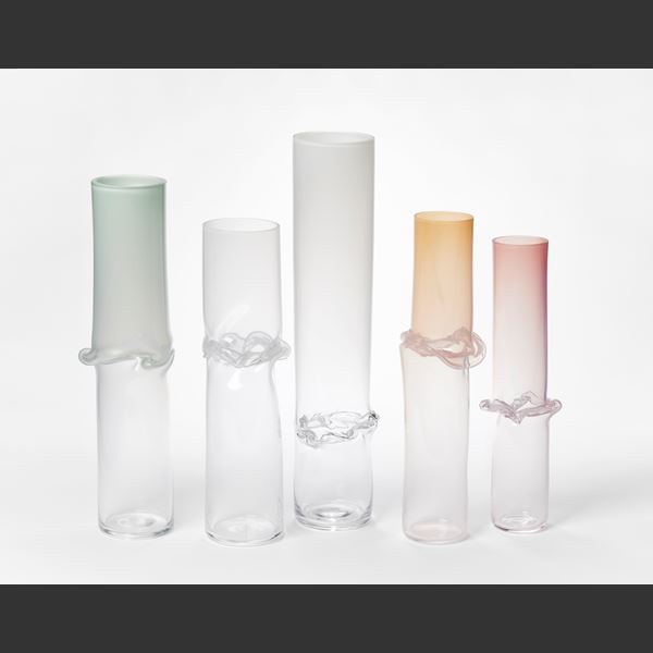 tall cylinder with transparent clear bottom half and opaque celadon green top half with central creased and slumped rippling and bulging waist hand made from glass