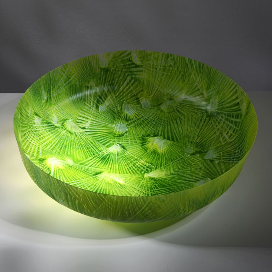 vibrant lime and mixed green low round centrepiece bowl with rounded base and short straight sides covered in angular abstract palm tree slight relief repeat patterns hand made from glass