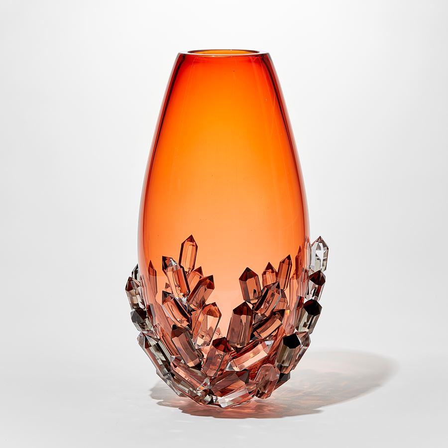 elegant ovoid teardrop shaped transparent rich peachy orange vase with lover third outside covered in cut crystals in clear grey and peach handblown and cut from glass