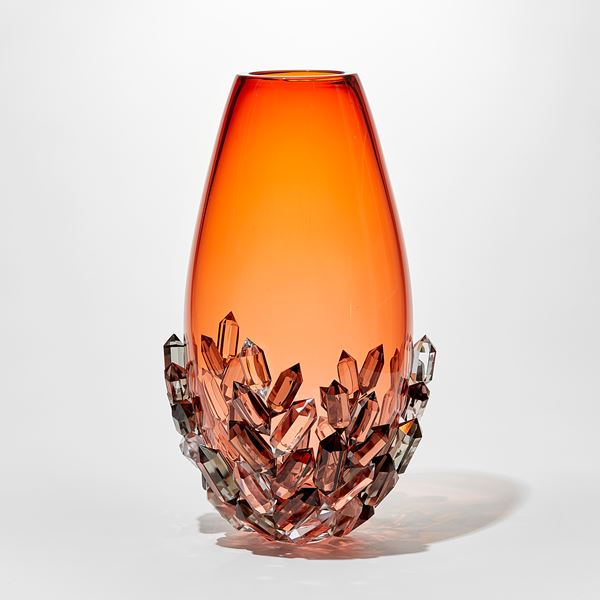 elegant ovoid teardrop shaped transparent rich peachy orange vase with lover third outside covered in cut crystals in clear grey and peach handblown and cut from glass