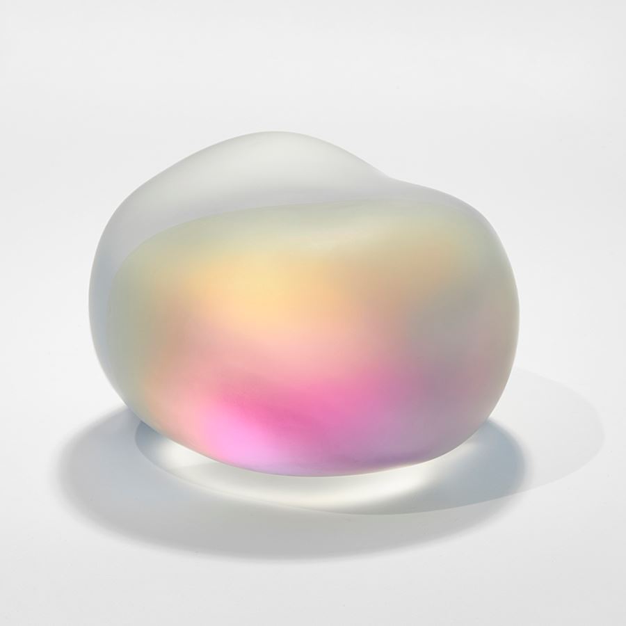 smooth amorphic glass pebble and rock inspired sculpture in matt clear glass with inner myriad of colours bursting from within as if there is a trapped shimmering mother of pearl light inside