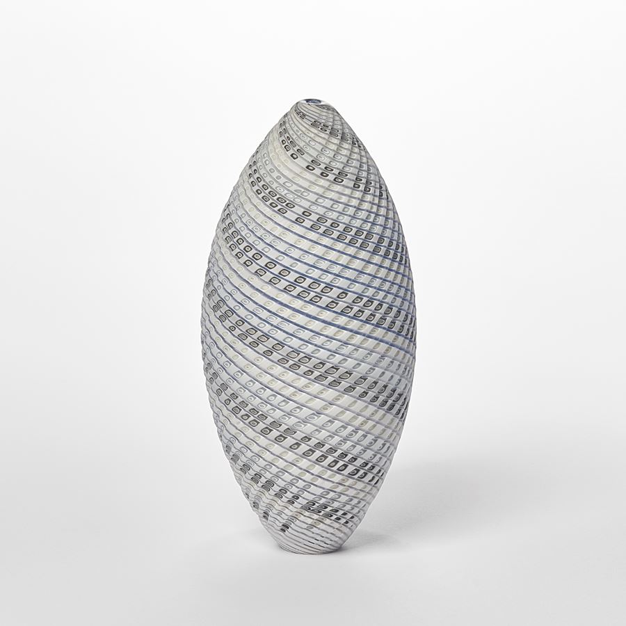 standing ovoid vessel with textured cut surface and lines of colour curling round the form in white grey soft blue and green handmade from glass