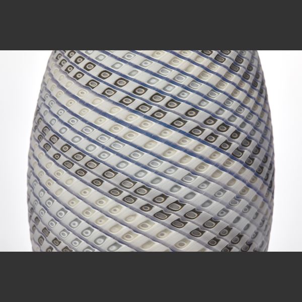 standing ovoid vessel with textured cut surface and lines of colour curling round the form in white grey soft blue and green handmade from glass