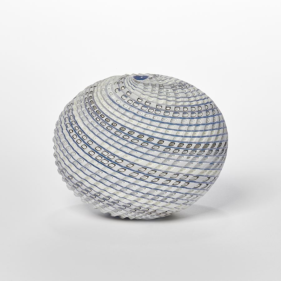 off white cream blue and soft green ovoid shaped vessel with spiralling lines in colour around the form and cut sections within the surface hand made from glass