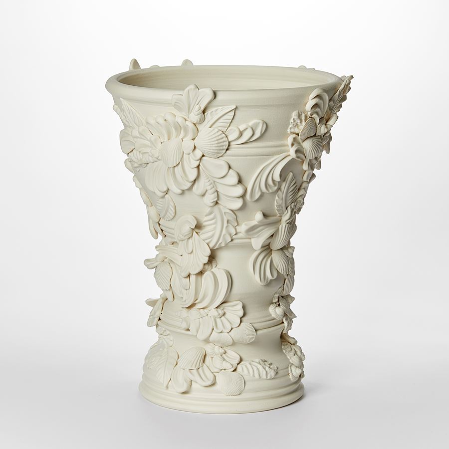 flared off white light cream alabaster vase covered in shells and architectural flourishes hand made from porcelain