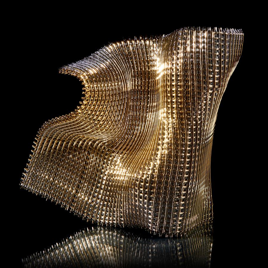 buckled square standing golden woven form with the movement and feel of falling fabric curling and twisting hand made from fused glass