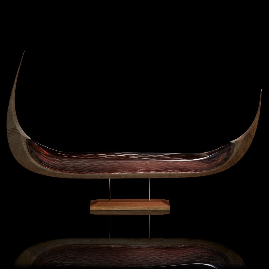 viking ship with oak keel with carved detail and aubergine tea coloured glass hull with cut texture raised on a simple two steel pinned base in wood hand made 