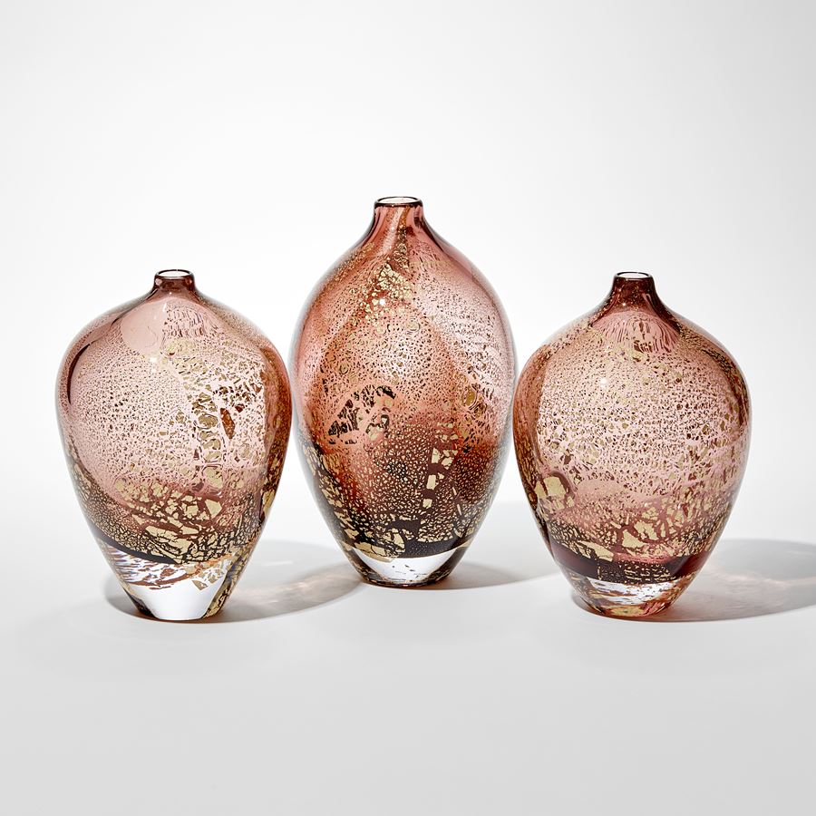 art glass sculptural vases in amber and aubergine with gold leaf-shaped speckles on exterior