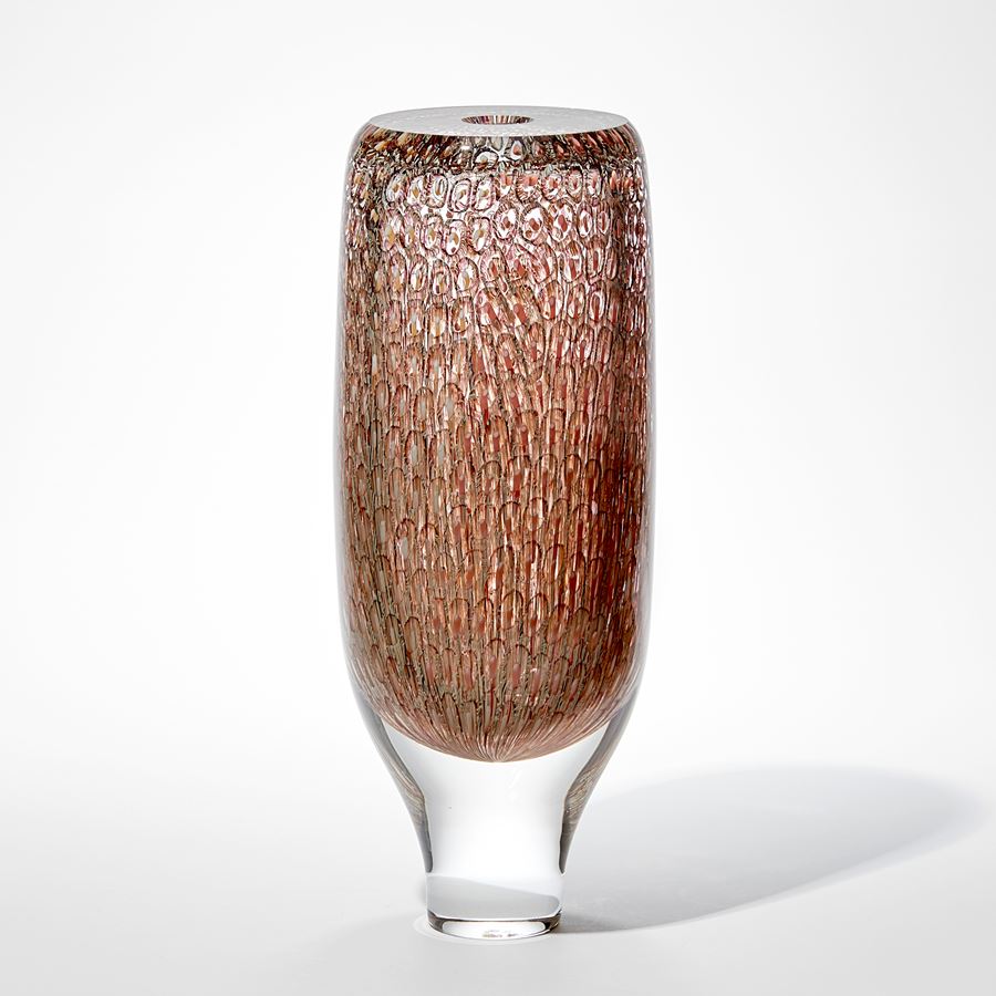 tall round clear chunky and heavy hand made glass vase with tapering base and flat top with intense detailed pattern trapped within in peach salmon coral and soft yellow