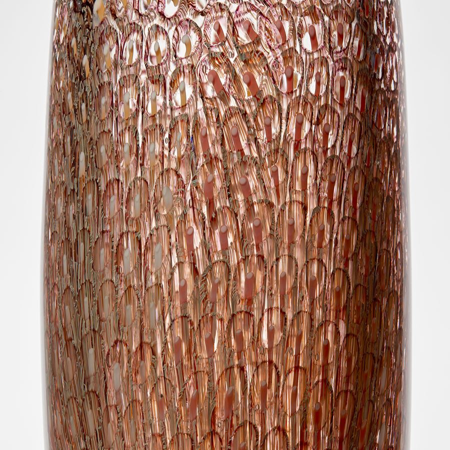 tall round clear chunky and heavy hand made glass vase with tapering base and flat top with intense detailed pattern trapped within in peach salmon coral and soft yellow