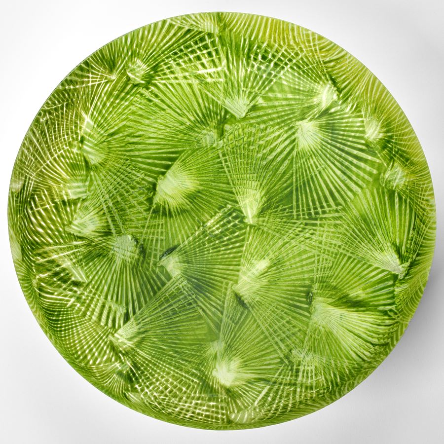 vibrant lime and mixed green low round centrepiece bowl with rounded base and short straight sides covered in angular abstract palm tree slight relief repeat patterns hand made from glass