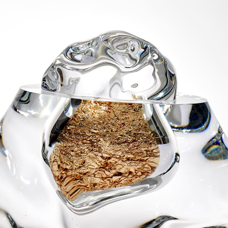 organic amorphous clear mass with internal hallow filled with crumpled gold leaf hand made from glass
