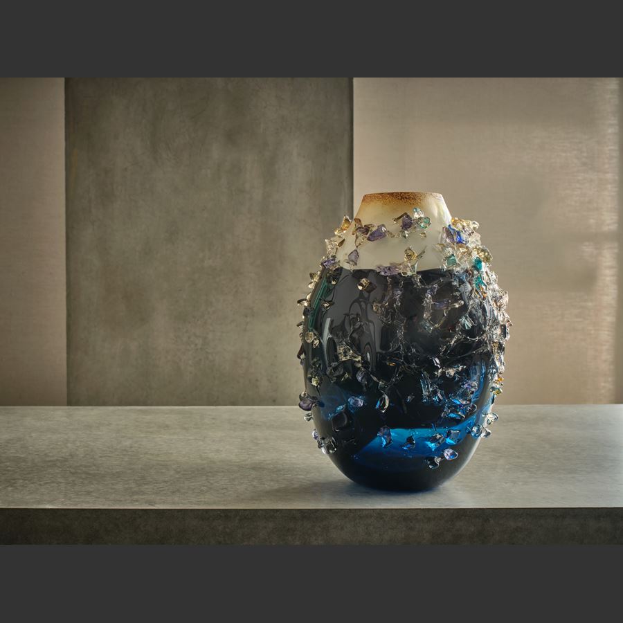 midnight blue body with soft milky cappuccino opaque top sculptural vase with multicoloured shards on the surface handmade from glass
