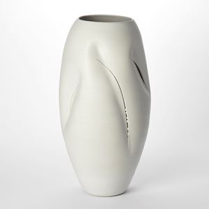 tall oval milky white vessel with soft crevasse indentations and curved thin brancusi style slash cut marks through the surface hand made and thrown from clay