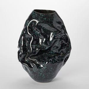 black glossy crumpled and wrinkled oval vessel with rich dark green speckles upon the surface hand made from white st thomas clay