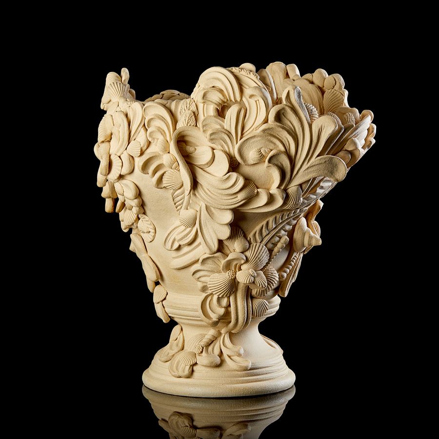 hand throw ceramic centrepiece in soft sand coloured clay with turned foot and covered in flourishes swirls and shells hand made