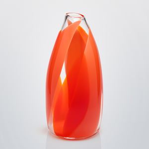 tall round pointed top with small opening clear vase with wide soft bands of colour in orange red and coral curling round the form from the base to the top hand made and blown from glass