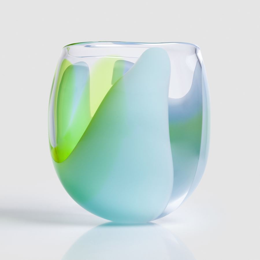tulip bud shaped clear hand blown glass bowl with soft abstract sections of colour in opaque lime green blue and light blue