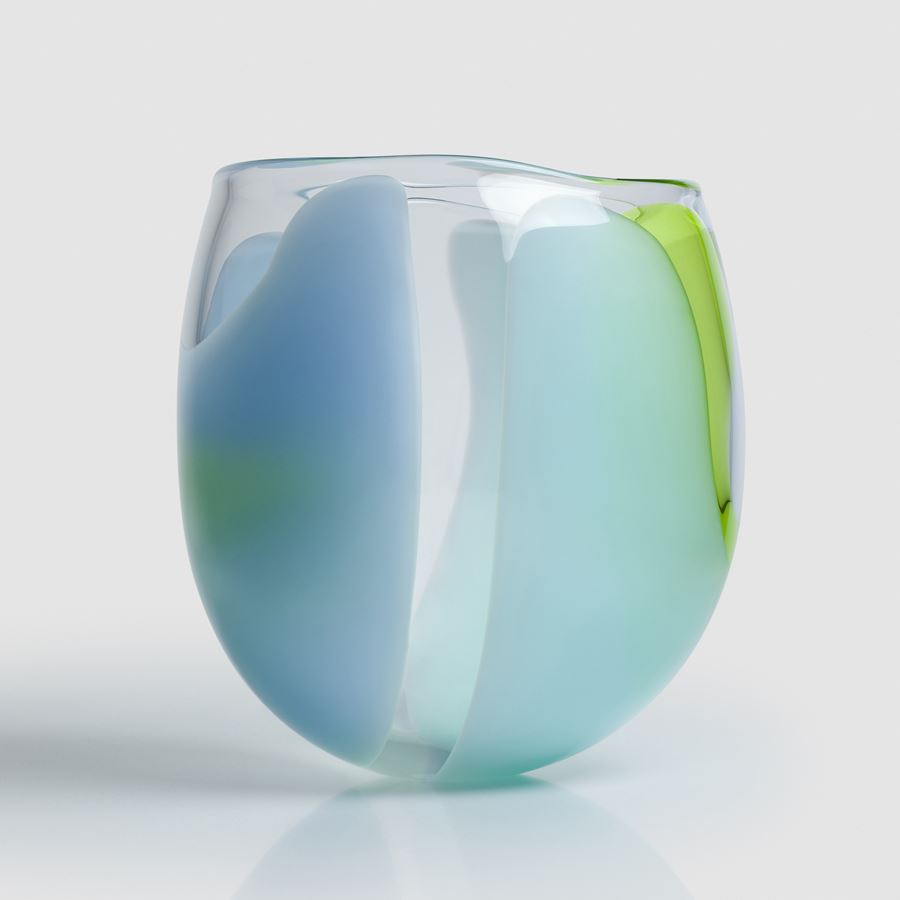 tulip bud shaped clear hand blown glass bowl with soft abstract sections of colour in opaque lime green blue and light blue