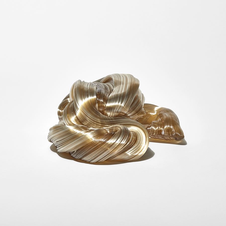 ridged glistening twisting piled candy cane mass in soft amber colour handmade from glass