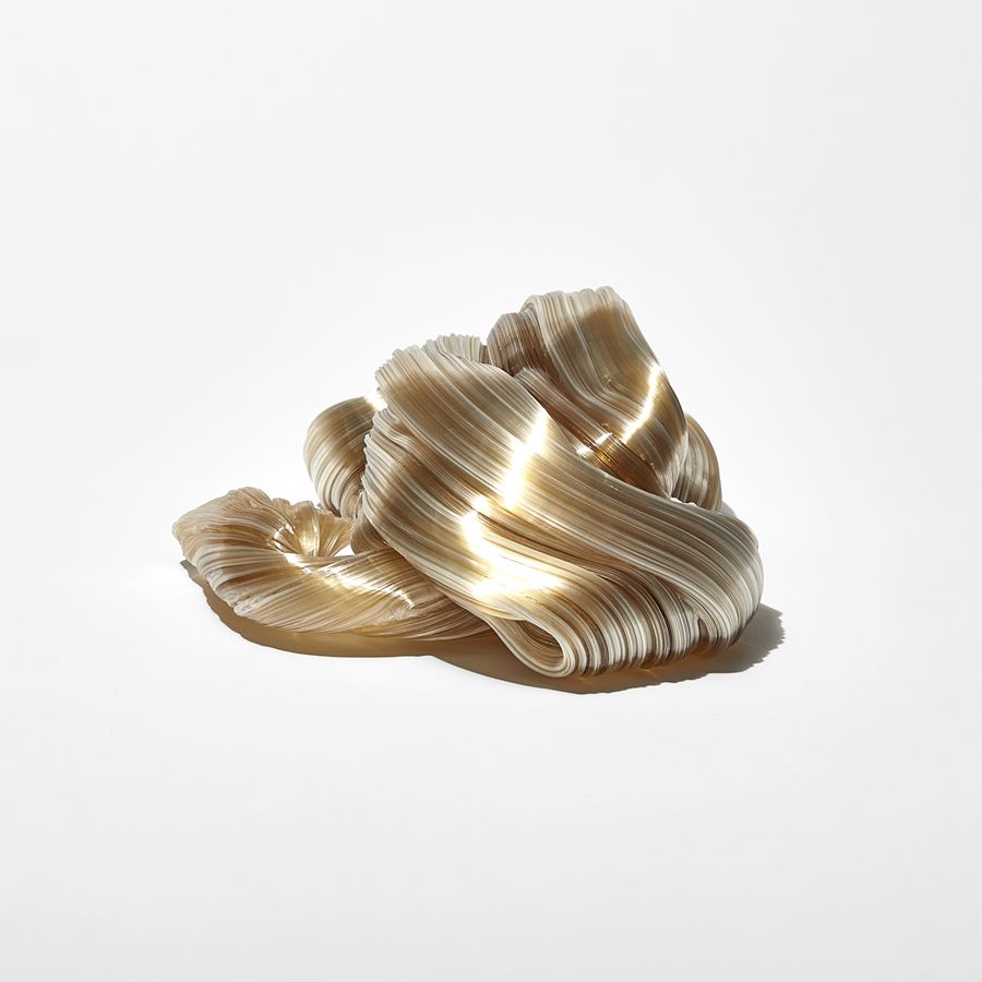 ridged glistening twisting piled candy cane mass in soft amber colour handmade from glass