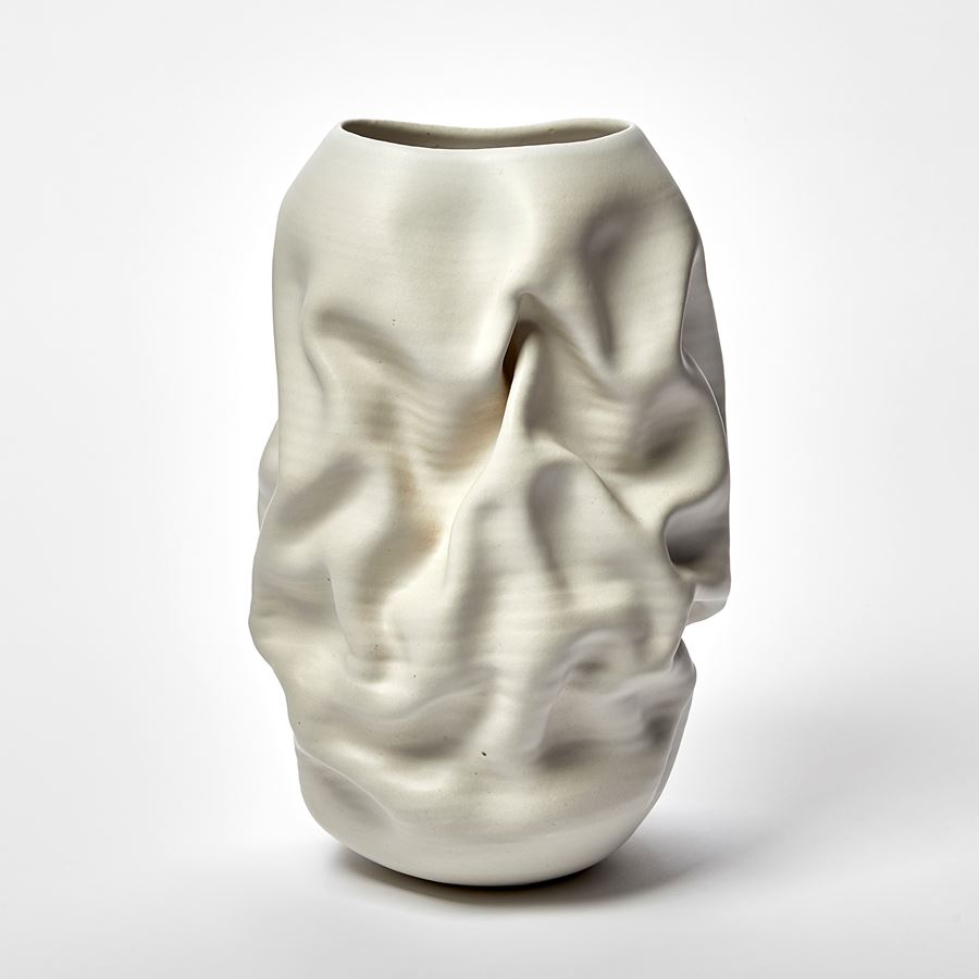 white standing wrinkled and ridged tall vase with oval top opening hand made from clay