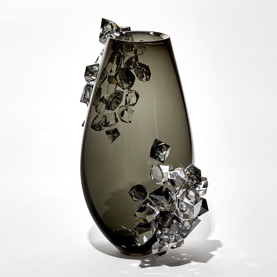 transparent black grey teardrop shaped vase with two sections densely covered in clear and grey crystals with ink swirls trapped within hand made from glass