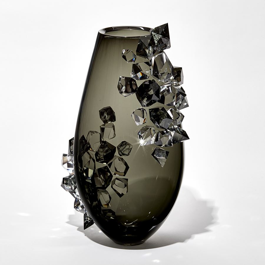 transparent black grey teardrop shaped vase with two sections densely covered in clear and grey crystals with ink swirls trapped within hand made from glass