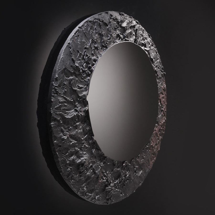 round black mirror glass artwork with cratered edge