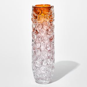 tubular clear vase with transparent base fading to pink and then bright rich orange at the top with the outer surface covered in oversized squished bubbles like bubblewrap handmade from glass